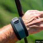 Home 19 등산 스틱과 손목 스트랩 사용법 - A detailed close-up of a hiker’s hands wearing trekking pole straps made of soft neoprene with ergon...